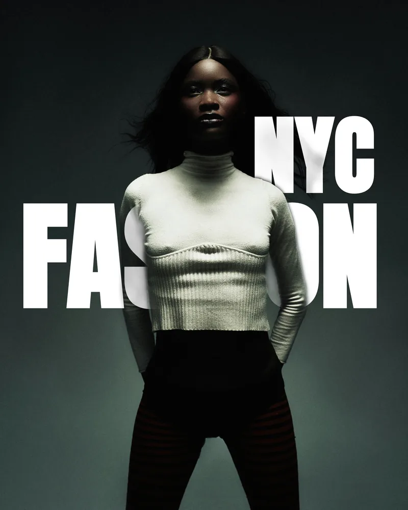A studio fashion portrait with NYC FASHION set in white type disappearing behind the model's arms and torso.
