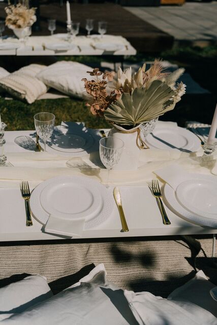 A set reception table with dried flowers, seen from above in hard light